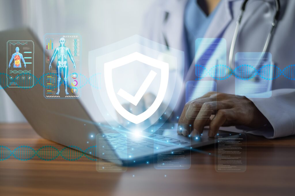 Healthcare professional using a laptop with digital medical records and security shield icon, symbolizing HIPAA eligible cloud solutions for protecting patient data.